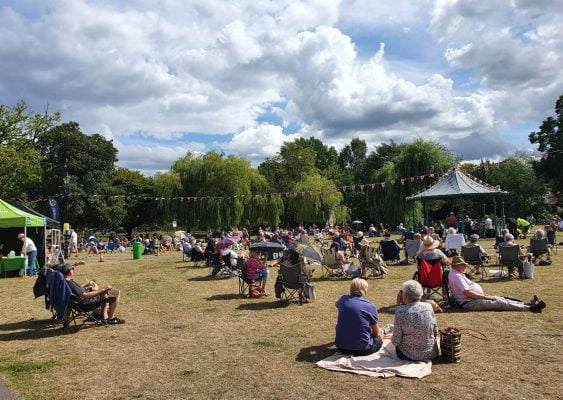People sitting on blankets in a park
