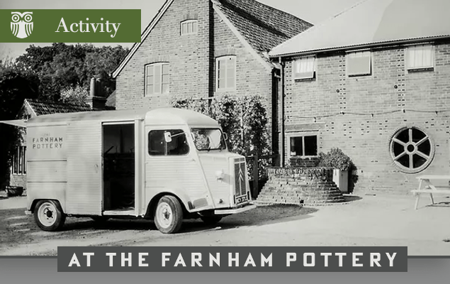 Old black and white photograph of the outside of a pottery and a lorry parked in front.