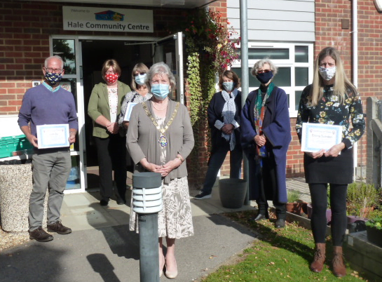 Group of people wearing masks and socially distancing.