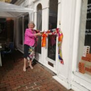 Mayor cuts ribbon at entrance to a building