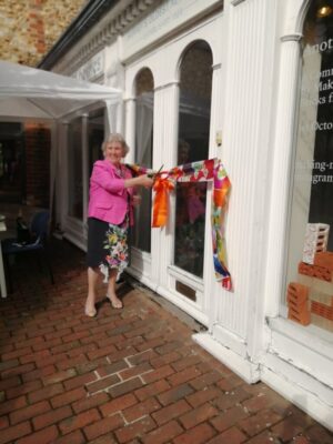 Mayor cuts ribbon at entrance to a building