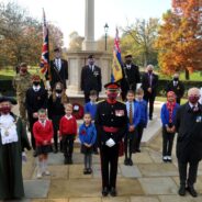 School children, the Mayor and others socially distance at the war memorial.