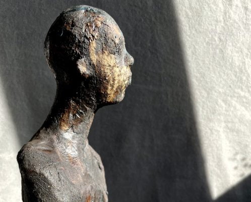 A ceramic sculpture of a person by Su Jameson