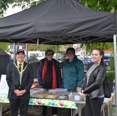 Mayor and Mayoress standing in front of a tea tent.