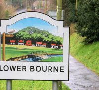 A village entry sign for Lower Bourne