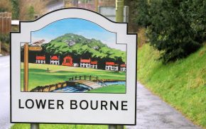 A village entry sign for Lower Bourne