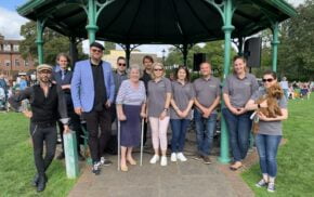 A group of people standing in front of a bandstand.