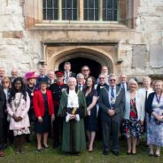 Group of people in formal dress standing outside a church