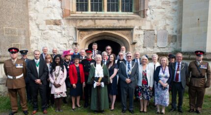 Group of people in formal dress standing outside a church