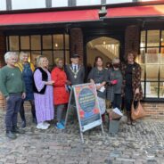 Group of people standing outside a shop