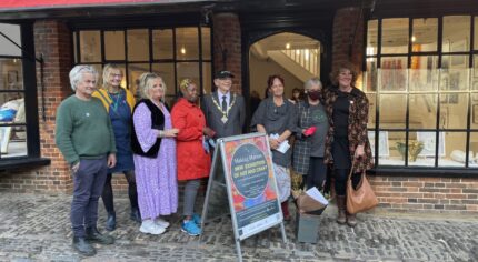 Group of people standing outside a shop