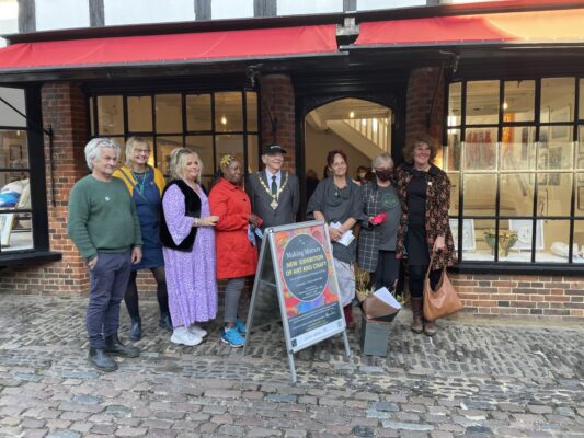 Group of people standing outside a shop
