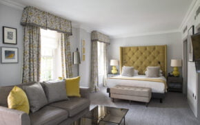 Hotel bedroom showing bed and sofa in foreground.