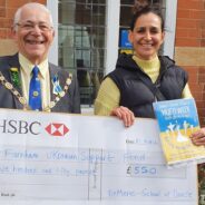 Male and female holding a large cheque