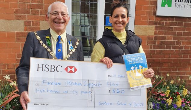 Male and female holding a large cheque