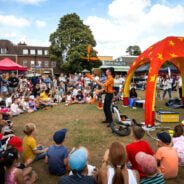 Crowd of people watching a man juggling