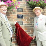 Two males unveil a plaque