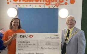 Male and female holding a large cheque