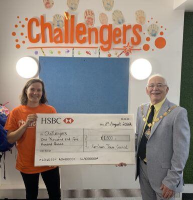 Male and female holding a large cheque
