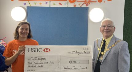 Male and female holding a large cheque