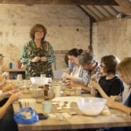 People sitting at a table doing a craft activity