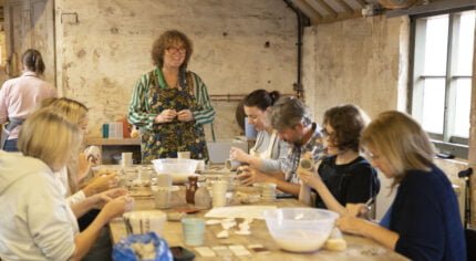 People sitting at a table doing a craft activity