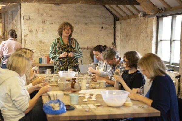 People sitting at a table doing a craft activity
