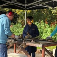 People standing at a work bench