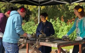 People standing at a work bench