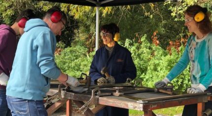 People standing at a work bench