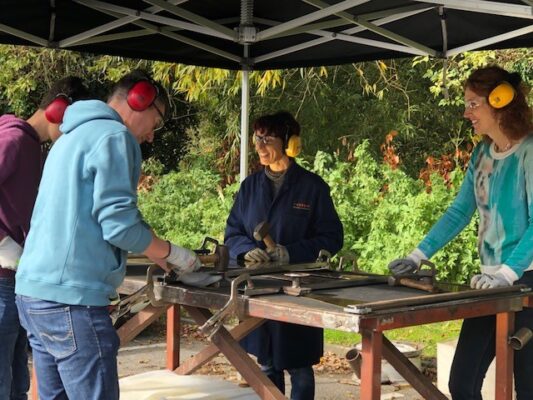 People standing at a work bench