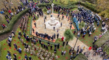 Aerial image of people taking part in a service at the war memorial