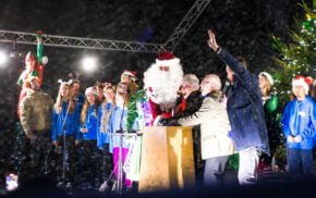 People huddled together on a stage.