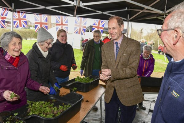 HRH The Duke of Edinburgh talking to people potting plants