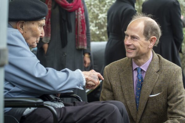 HRH The Duke of Edinburgh talks to a man in a wheelchair.
