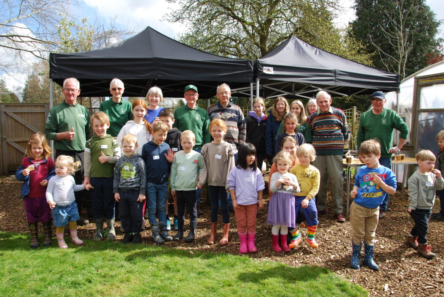 Group of children and adults in outside space.