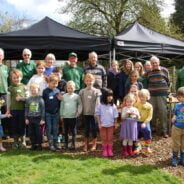 Group of children and adults in outside space.