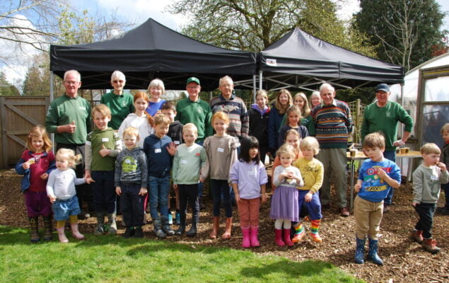 Group of children and adults in outside space.