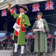 Town crier and Mayor on stage.