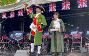 Town crier and Mayor on stage.
