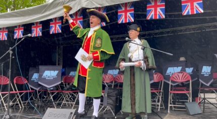 Town crier and Mayor on stage.