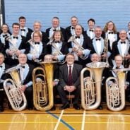 A group photo featuring the band members of the Alder Valley Brass band with their instruments
