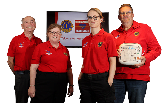 A photo showing two women and two men, one holding an Automated External Defibrillator