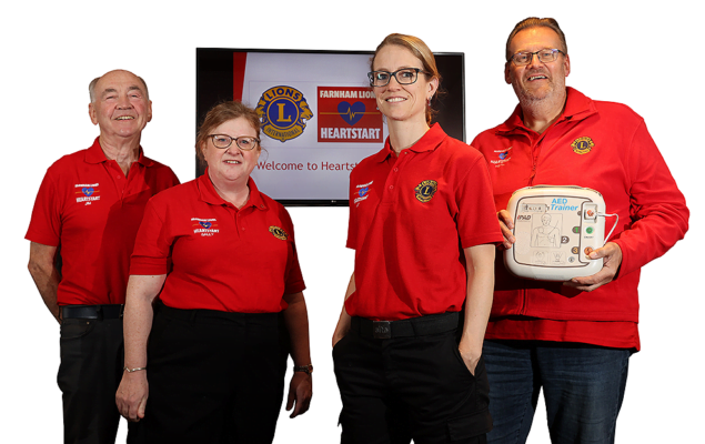 A photo showing two women and two men, one holding an Automated External Defibrillator