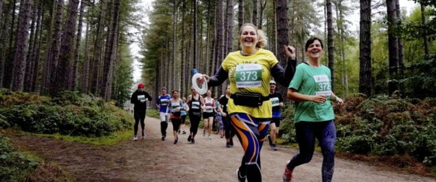 A group of people running in a forest
