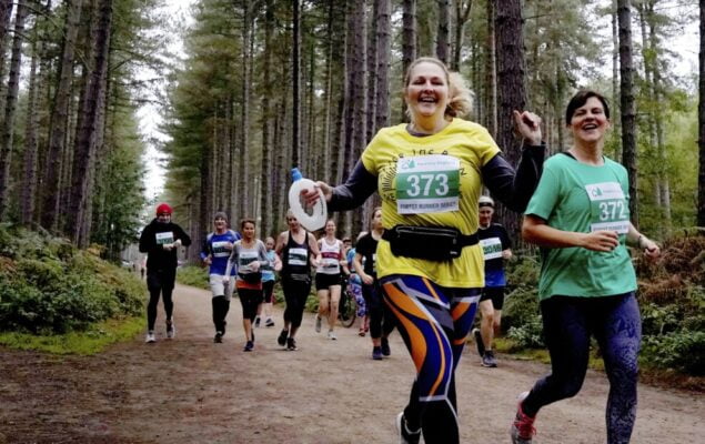 A group of people running in a forest