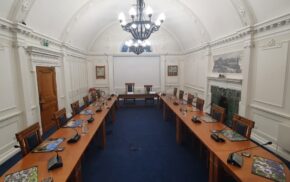 A formal room with tables set up in a conference style.