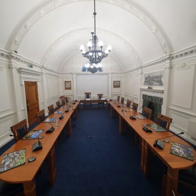 A formal room with tables set up in a conference style.