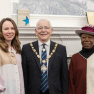 Two females standing with the Mayor.