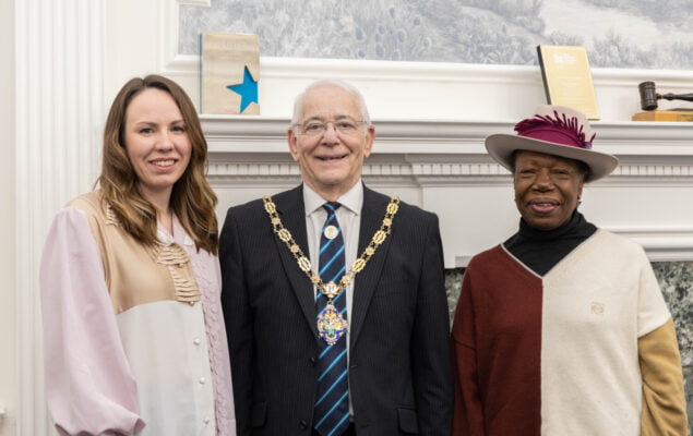 Two females standing with the Mayor.